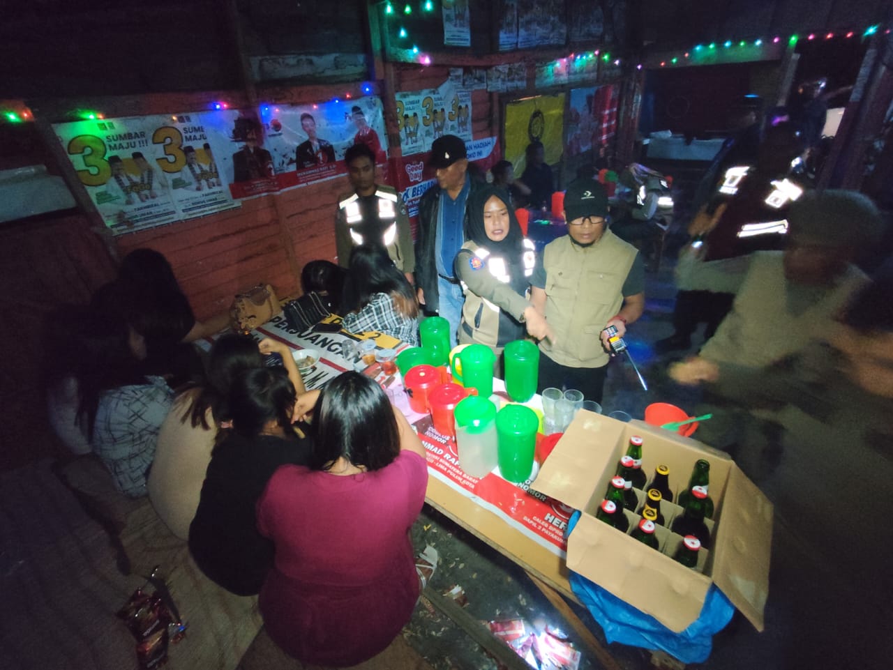 Petugas mengamankan sejumlah perempuan muda saat razia di sebuah kedai tuak remang-remang di Jorong Piladang, Sabtu (7/6/2025) malam. (Ist)